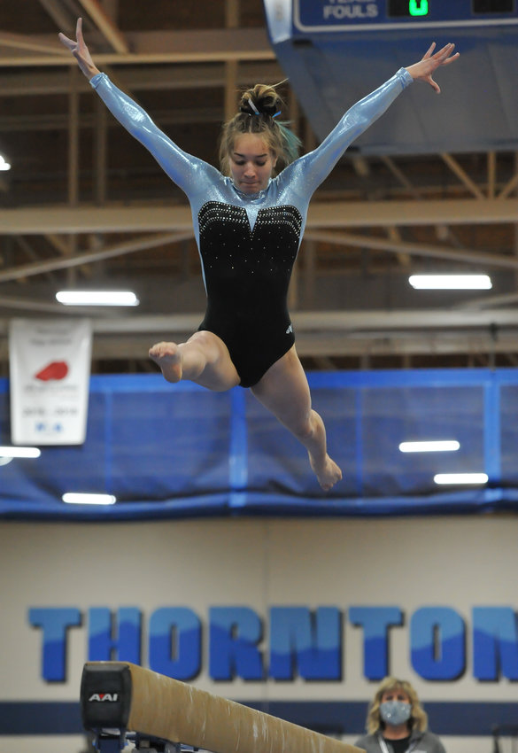 Mountain Range senior gymnast Melina Andretich rises above the balance beam during CHSAA's 5A state gymnastics championships April 22 at Thornton High School.